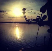 Bow raised at sunset over the water